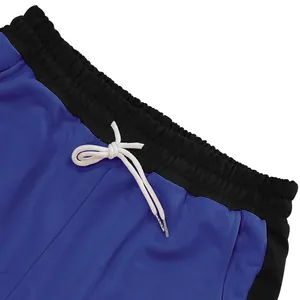 Close-up detail of heavy men's sweatpants with white drawstring and elastic waistband.