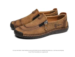 Close-up of handcrafted men's brown leather loafers with stylish side zipper details and moccasin stitching.