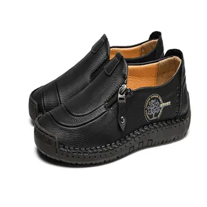 Close-up of black leather men's loafers with side zipper and decorative stitching