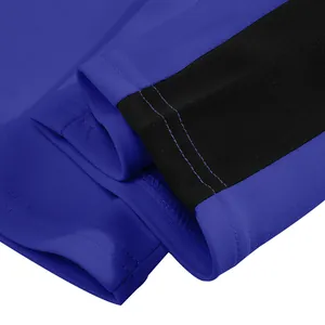 Detailed close-up of heavyweight blue and black sweatpants with double-needle stitching