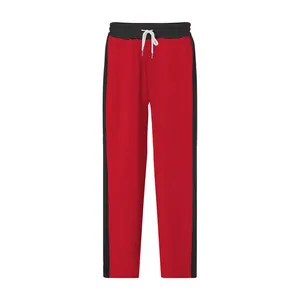 Detail view of men's red sweatpants with black side stripes and white drawstring design.