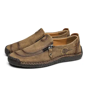 Men's casual brown leather loafers with side zipper and handmade stitching details.
