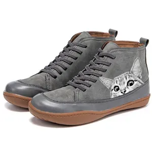 Side view detail of grey high-top Martin boots featuring a cute tabby cat print.