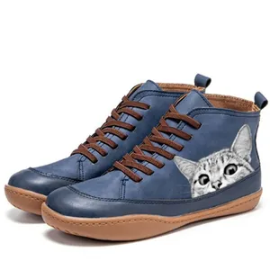 Close-up of blue high-top Martin boots with a cute cat print and brown laces, retro style
