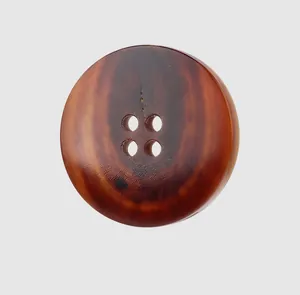 Detailed macro view of a natural water buffalo horn button with unique brown grain