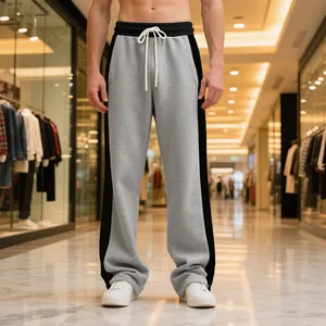 Macro view of heavy grey sweatpants featuring black side stripes and white drawstring