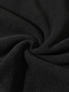 Macro view of soft black coral fleece fabric texture for men's winter sweatshirt detail