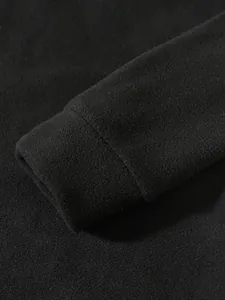 Close-up detail of a men's black coral fleece sweatshirt cuff with soft texture