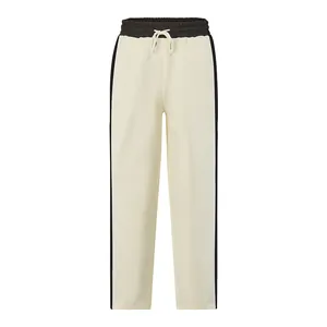 Detail of men's cream French Terry sweatpants featuring black side stripes and drawstring