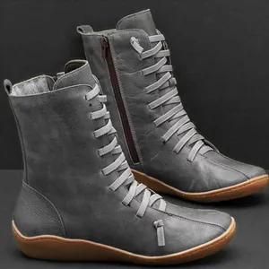 Close-up of grey mid-calf boots with unique horizontal lacing and side zipper.