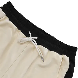 Detail of heavyweight drawstring sweatpants with contrast waistband and loopback fabric