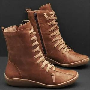 Classic brown faux leather ankle boots with detailed lace-up and functional side zipper