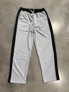 Flat lay view of men's loose drawstring sweatpants with contrast side stripes
