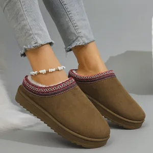 Detail view of brown winter snow boots with ethnic embroidered trim and warm lining