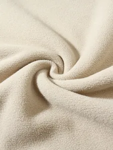 Close-up detail of soft beige coral velvet fleece fabric for men's winter hoodie