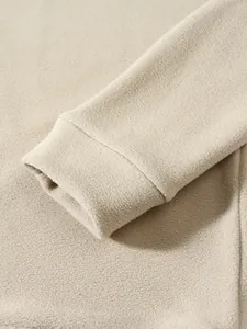 Close-up detail of soft coral fleece sweatshirt cuff showing the warm fabric texture