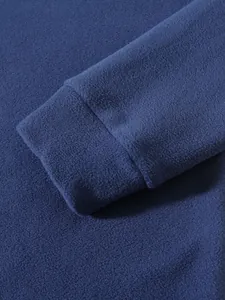 Detailed view of soft navy blue coral fleece fabric and sleeve cuff on men's sweatshirt