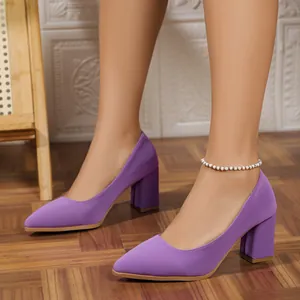 Close-up of elegant purple pointed-toe pumps with stable block heel and matte finish