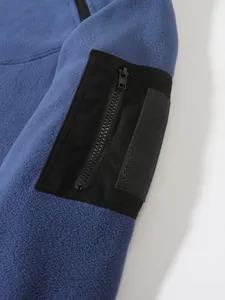Macro detail of men's blue coral fleece sweatshirt featuring black tactical arm pocket.