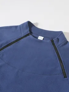 Close-up of men's fleece sweatshirt with dual diagonal zippers and stand collar