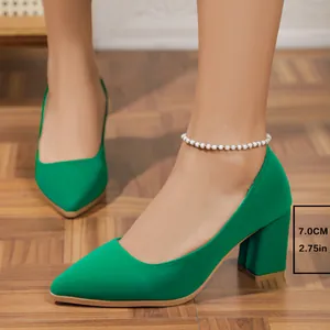 Close-up view of elegant bright green pointed-toe block heel pumps featuring a 7cm heel height