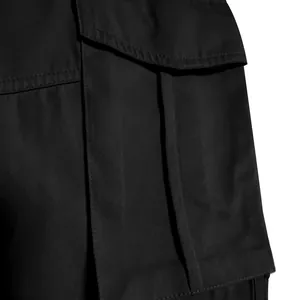 Close-up detail of black cargo pants pocket showing durable twill fabric and stitching