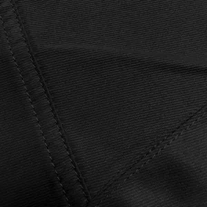Close-up of durable black fabric texture and reinforced double stitching on trousers.
