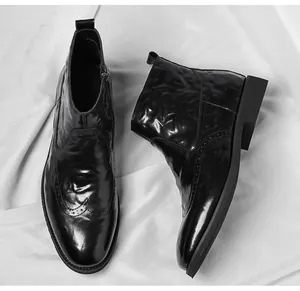 Detailed view of black brogue Chelsea boots with hand-scratched leather texture
