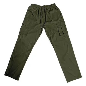 Close-up of olive green cargo pants with drawstring waist and flap pockets.
