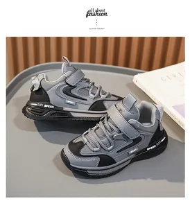 Detailed view of grey leather boys' sneakers featuring velcro straps and sporty design