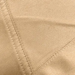 Close-up detail of beige cargo pants showing durable stitching and fabric texture