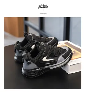 Side profile of children's black sneakers with stylish white wave accents on the side