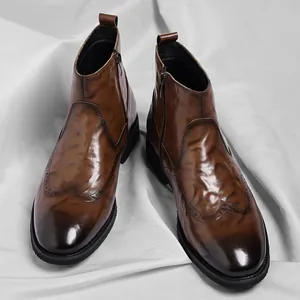 Classic British style brown leather Chelsea boots with brogue wingtip detailing