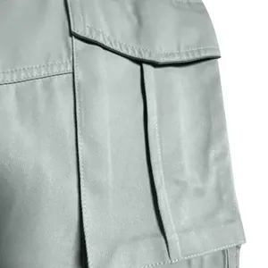 Close-up detail of gray cargo pants pocket showing durable stitching and fabric texture
