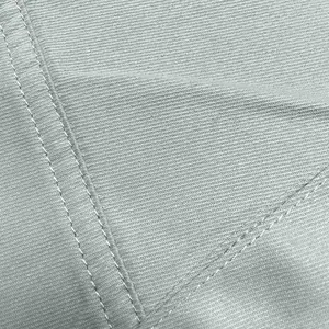Macro view of light gray fabric texture and double-needle stitching on cargo pants