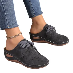 Comfortable women's dark grey closed-toe wedge mules featuring lace-up and hollow-out details