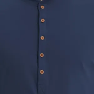 Close-up detail of navy blue Henley shirt with five brown buttons and soft cotton texture.