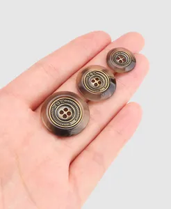 Macro detail of premium brown resin buttons with antique bronze metallic inlay