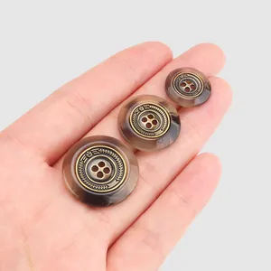 Elegant resin buttons with antique brass decorative center in three sizes for garments