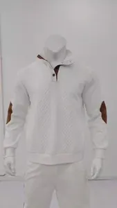 Close-up of white jacquard knit sweatshirt featuring brown elbow patches and Henry collar.