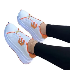 Women's thick-soled white sneakers with orange accents for casual sporty look