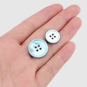 High-end light blue iridescent Japanese imported shell buttons for clothes in hand