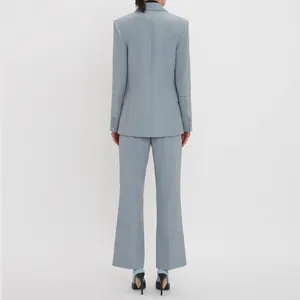 Elegant light blue women's suit with premium buttons back view for professional look