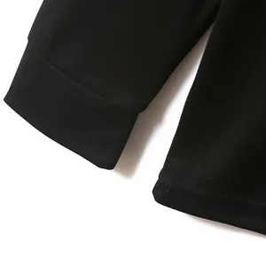 Makro-Detail des Ärmelbündchens und der Stofftextur eines schwarzen Golf-Poloshirts