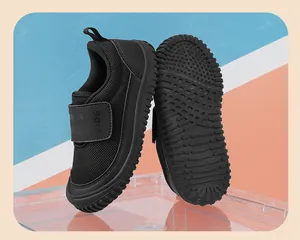 Close-up of black breathable mesh children's shoes featuring a durable grippy sole