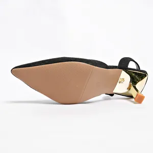 Close-up view showing the anti-slip sole and gold metallic heel of black slingback sandals.
