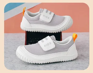 Detail view of breathable grey and white children's casual sneakers with velcro strap