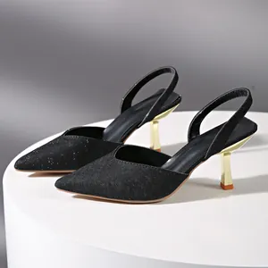 Side view of elegant black pointed-toe slingback heels with sleek golden stiletto heels.