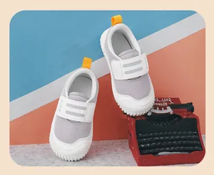 Breathable kids walking shoes with mesh upper and white velcro strap.