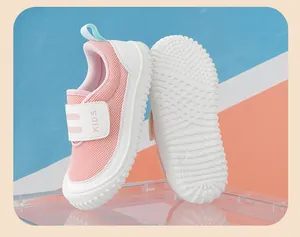 Close-up of pink breathable kids sneakers with white grooved non-slip rubber outsole